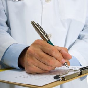 General Practitioner writing referral information